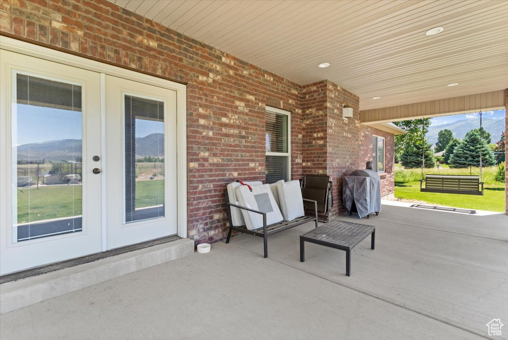 View of patio / terrace featuring french doors, grilling area, and a mountain view