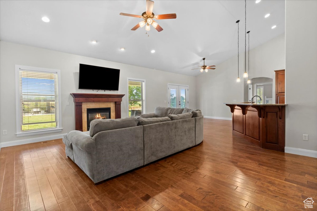Living room with ceiling fan, baseboards, a tile fireplace, dark wood-style flooring, and recessed lighting