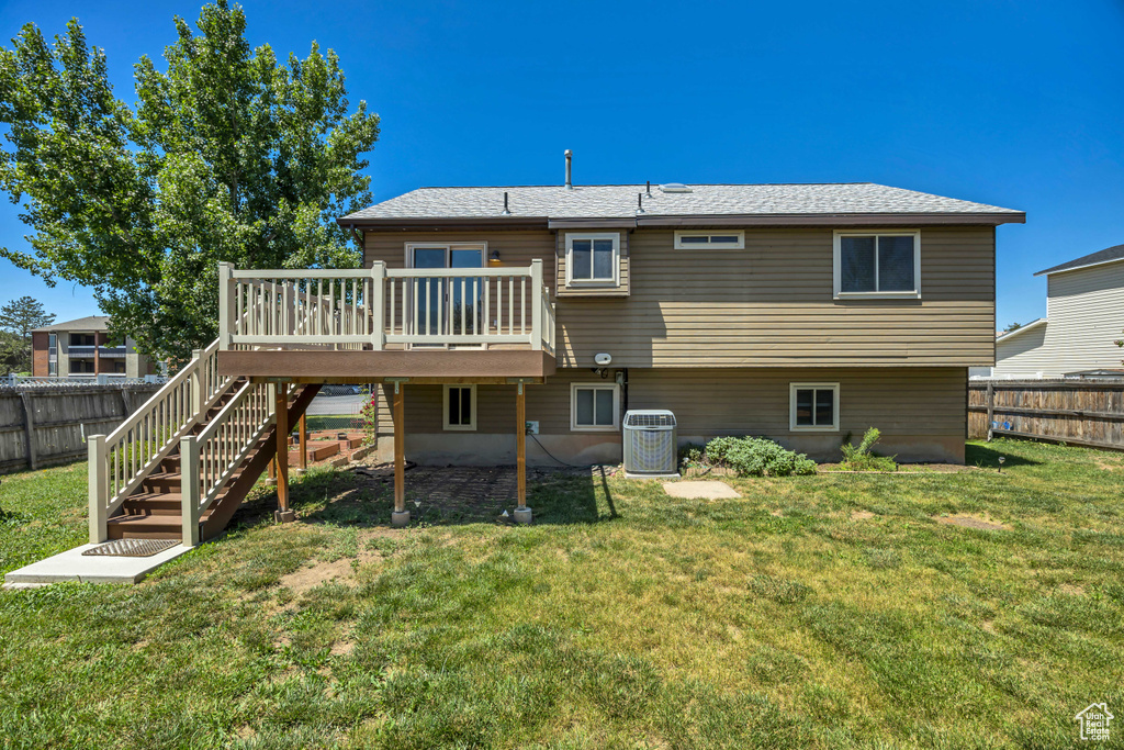 Back of property with a deck and stairs