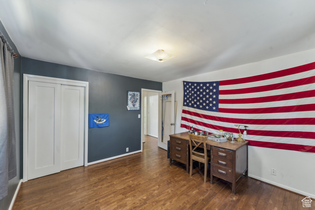 Bedroom featuring wood finished floors and baseboards