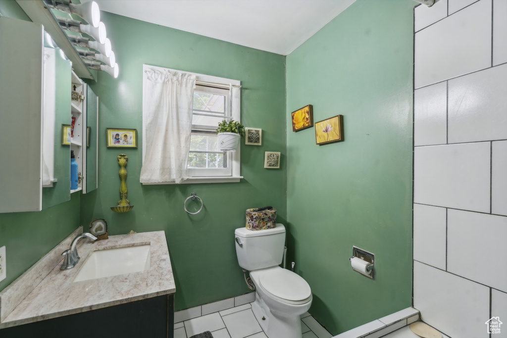 Bathroom with vanity, toilet, and tile patterned flooring