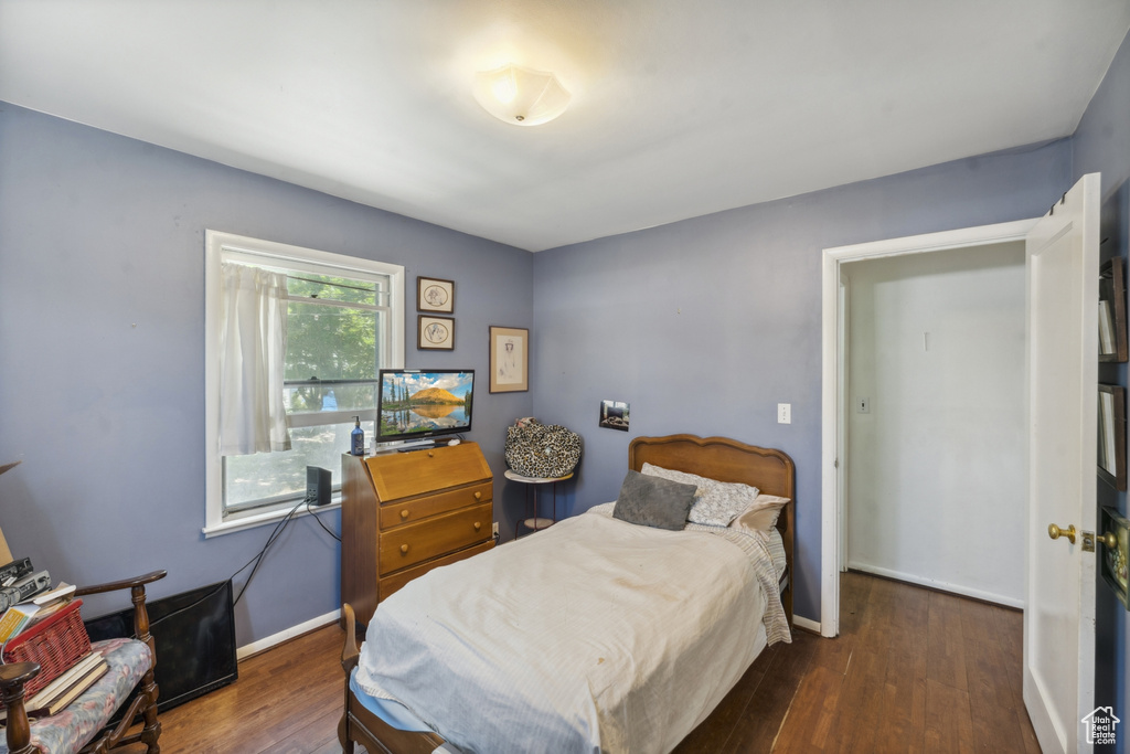 Bedroom featuring wood finished floors and baseboards