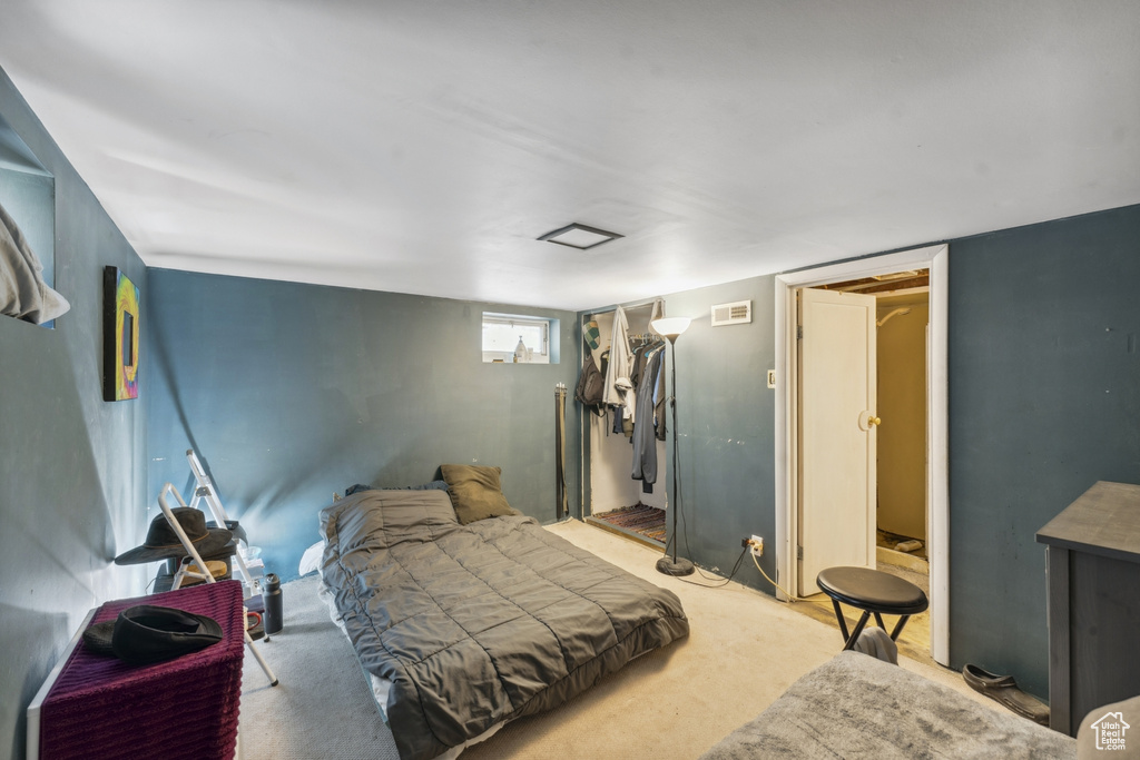 Bedroom with a closet and light carpet