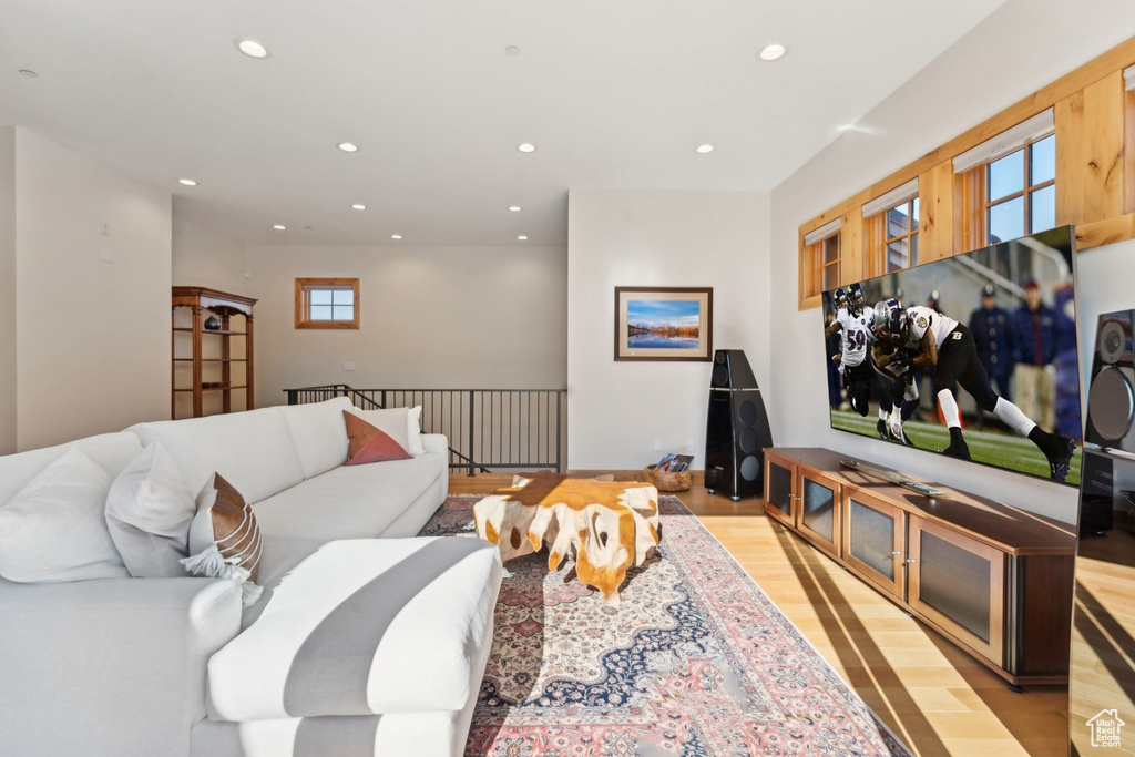 Living area with recessed lighting and light wood-style flooring