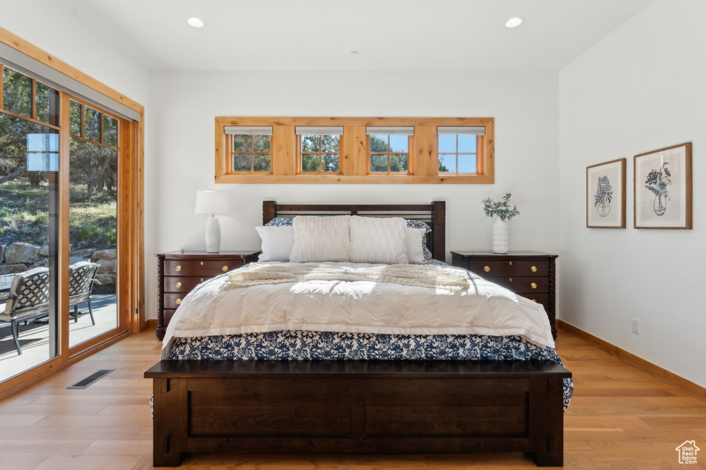 Bedroom with access to exterior, light wood finished floors, baseboards, and recessed lighting