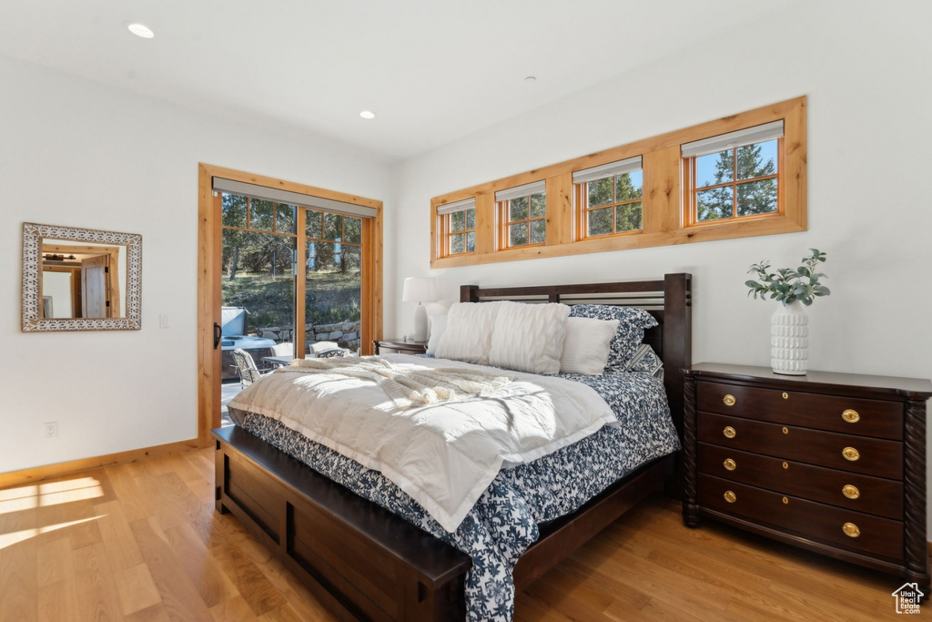 Bedroom featuring access to exterior, light wood-type flooring, baseboards, and recessed lighting
