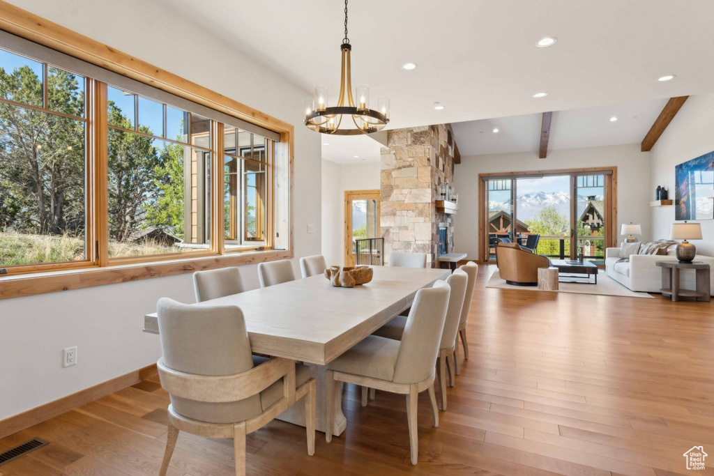 Dining room with beamed ceiling, a chandelier, light wood-style flooring, recessed lighting, and baseboards