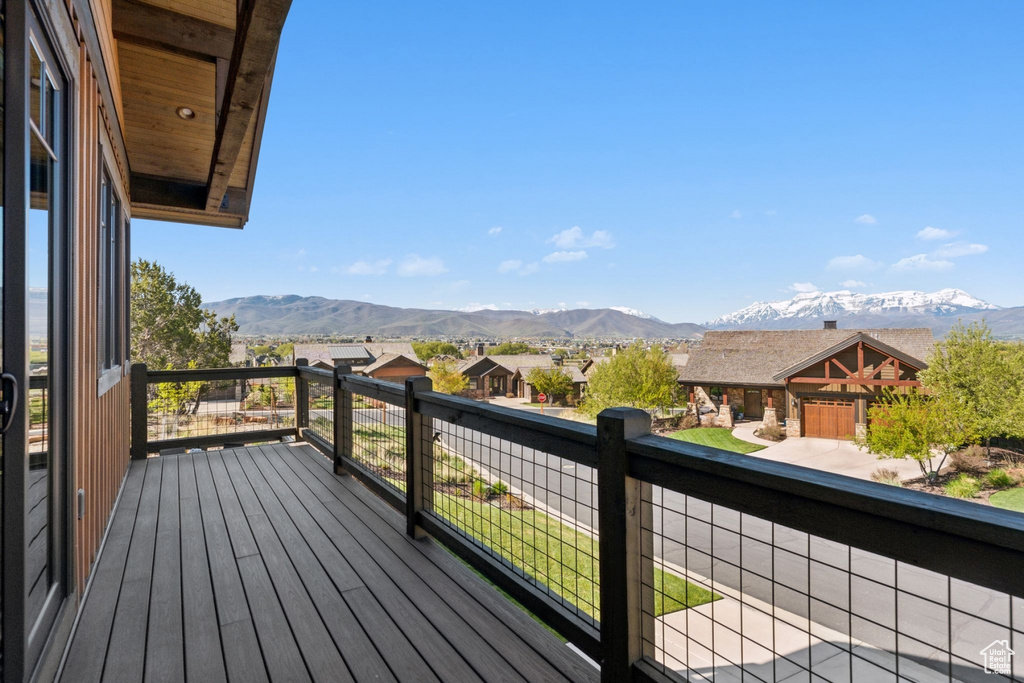Wooden terrace featuring a mountain view and a residential view