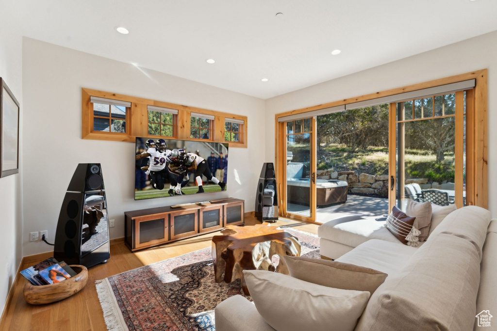 Living area with wood finished floors and recessed lighting