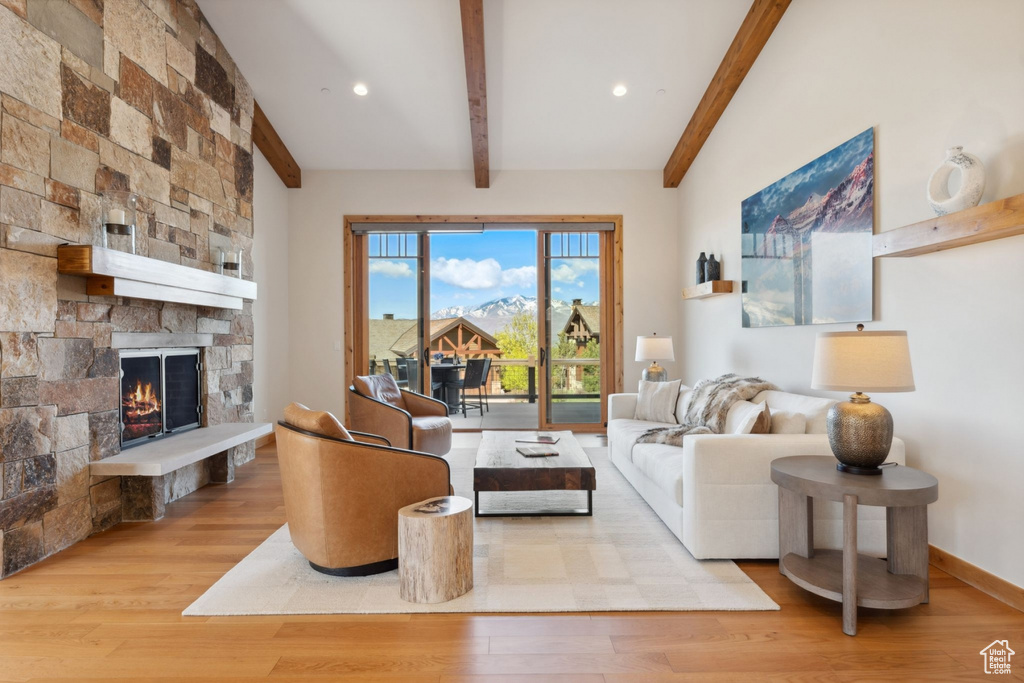 Living area with wood finished floors, a fireplace, and recessed lighting