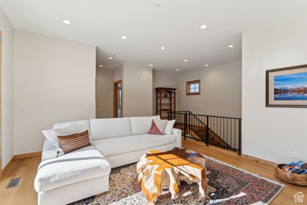 Living area with light wood-style flooring, recessed lighting, and baseboards