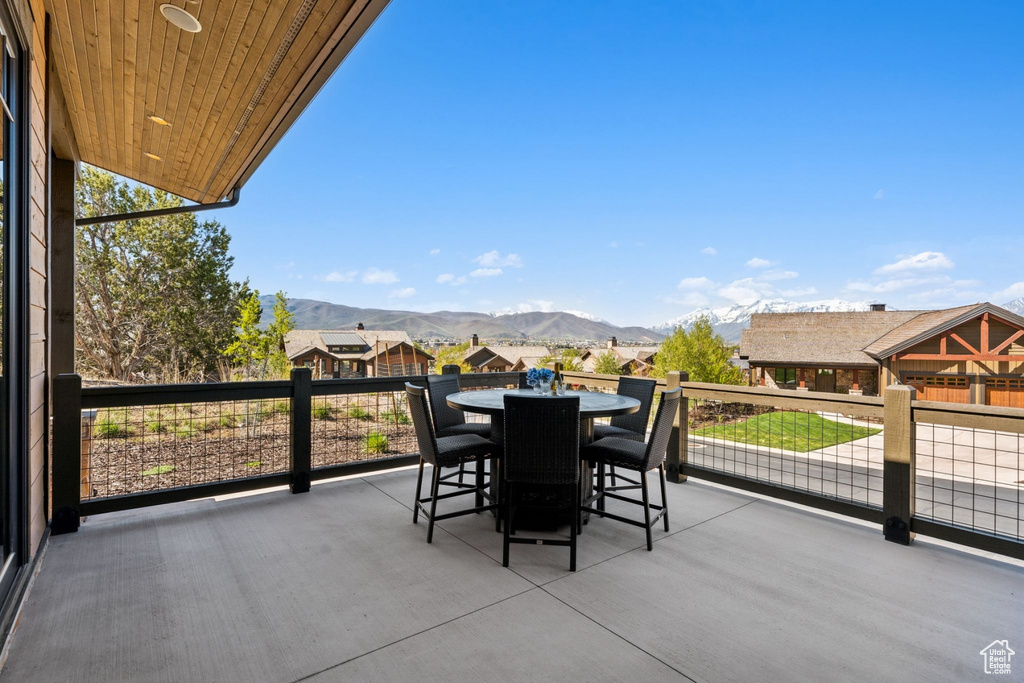 View of patio / terrace with a mountain view, outdoor dining space, and a balcony