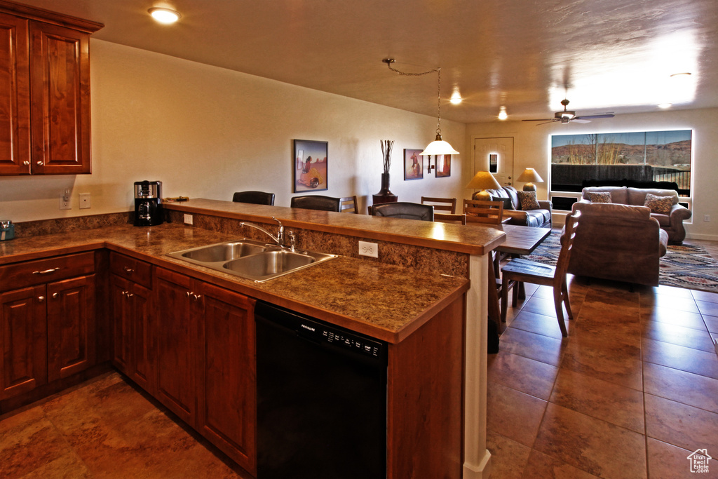 Kitchen with dishwasher, a sink, a peninsula, open floor plan, and dark countertops