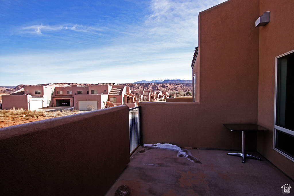 Balcony featuring a residential view and a mountain view