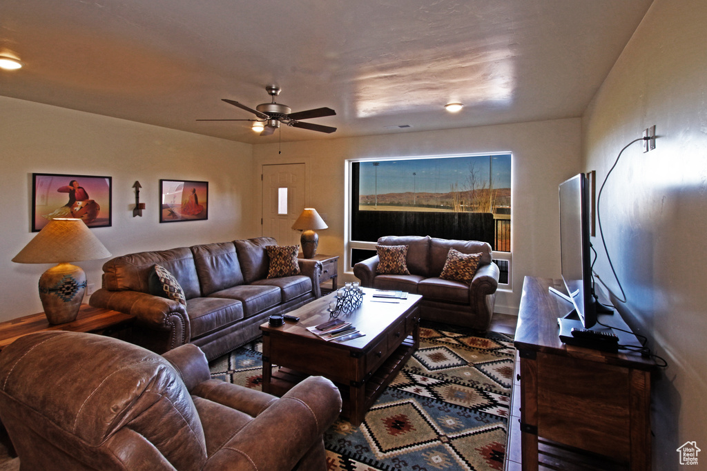 Living room featuring a ceiling fan and wood finished floors