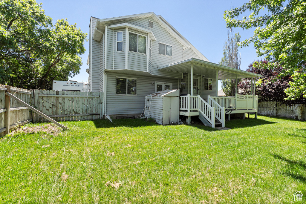 Back of property featuring a wooden deck