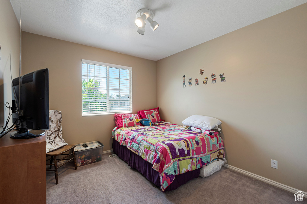 Carpeted bedroom featuring baseboards and ceiling fan