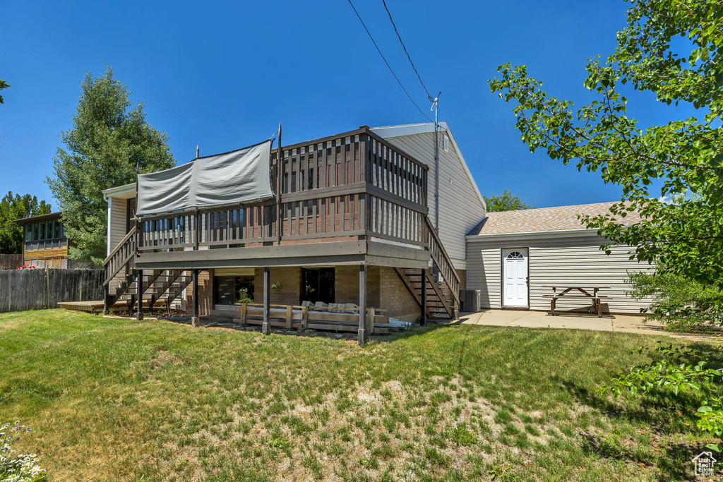 Rear view of house featuring stairs, a wooden deck, central AC unit, and a patio area