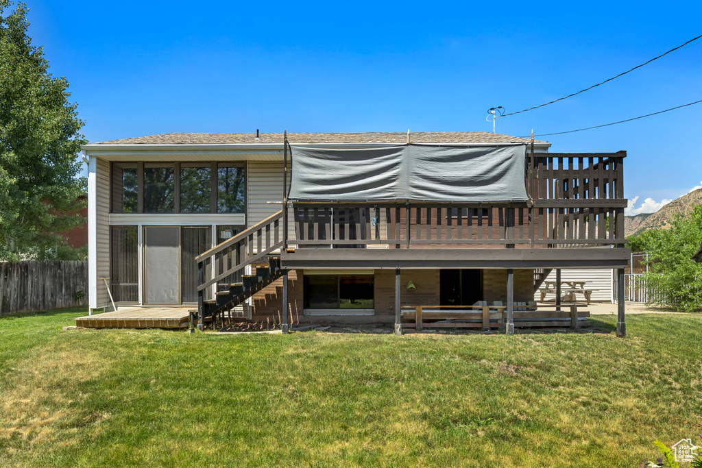 Back of house with stairway and a deck