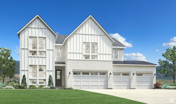 Modern farmhouse featuring board and batten siding, a front yard, concrete driveway, metal roof, and a standing seam roof
