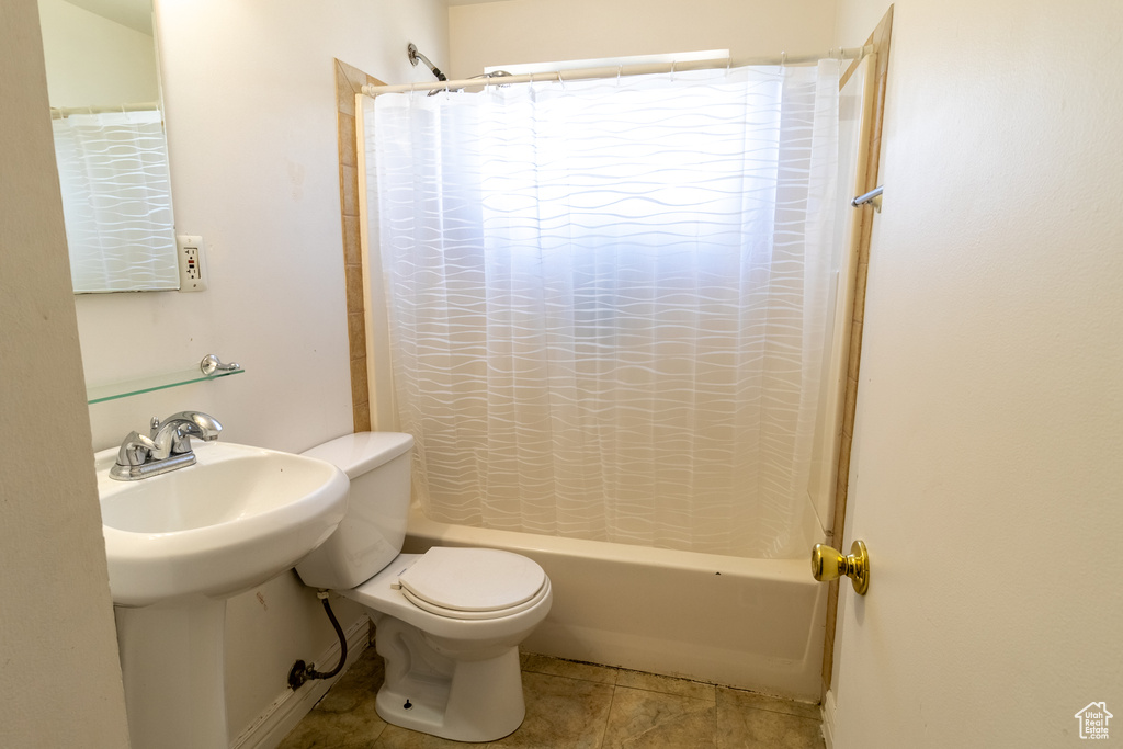 Bathroom with toilet, shower / bath combination with curtain, and tile patterned floors