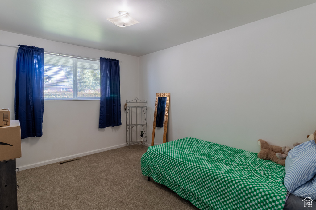 Carpeted bedroom with baseboards