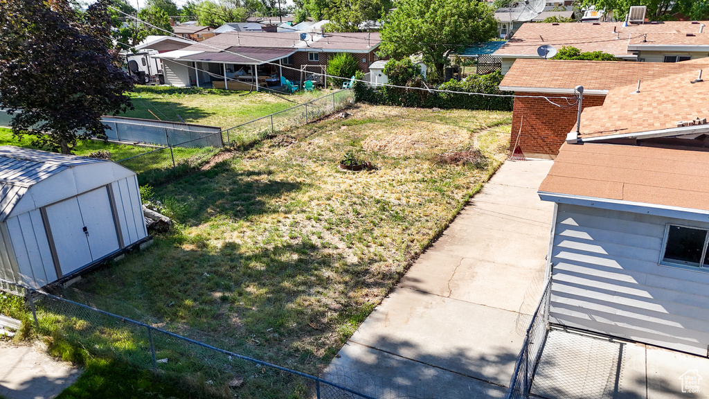 Fenced backyard featuring a residential view