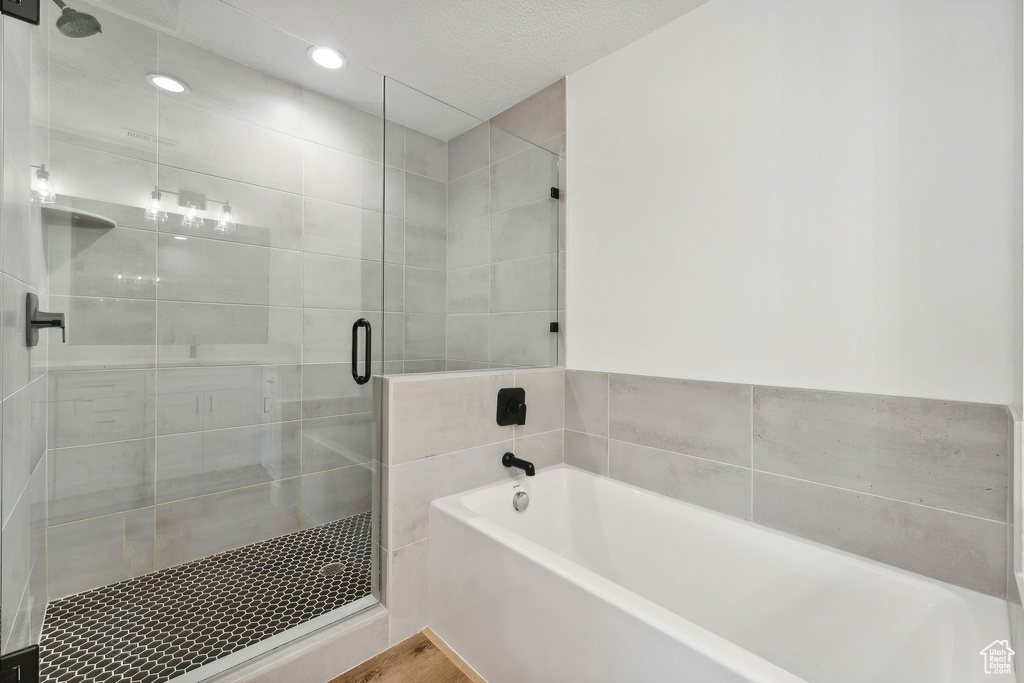 Full bathroom with a bath and a shower stall