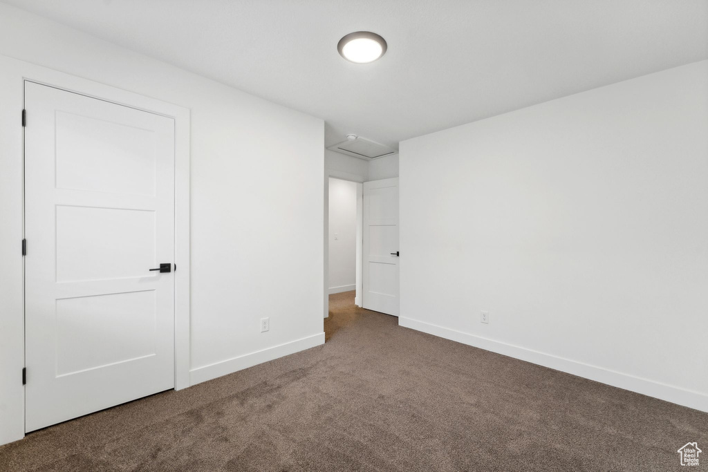 Unfurnished bedroom with carpet flooring and baseboards