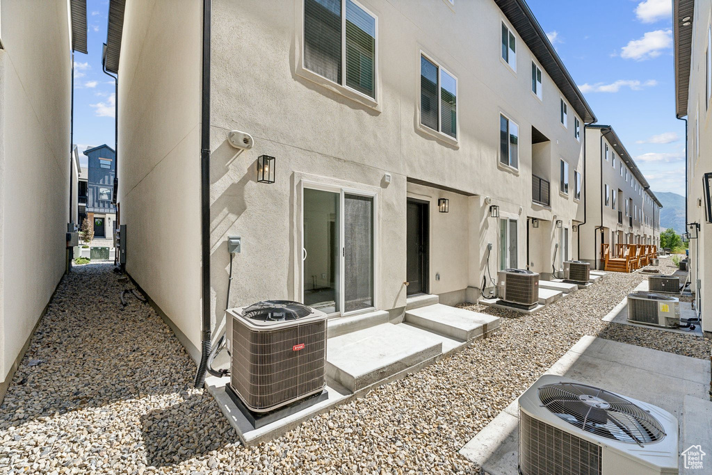 Back of property featuring central air condition unit and stucco siding