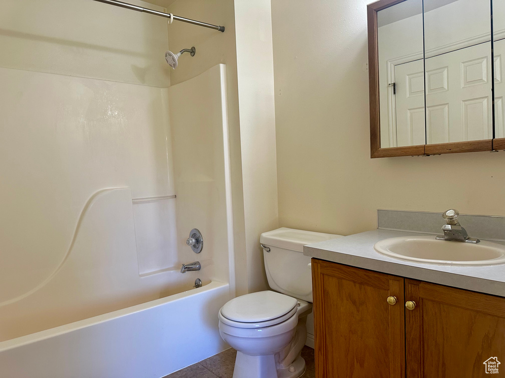 Full bath featuring vanity, tub / shower combination, and tile patterned floors