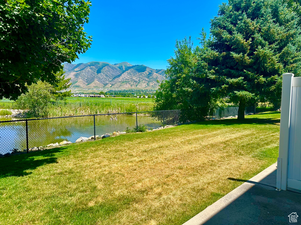 View of yard featuring a water and mountain view