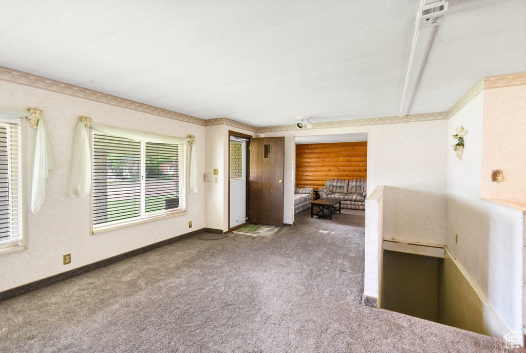 Carpeted spare room with baseboards