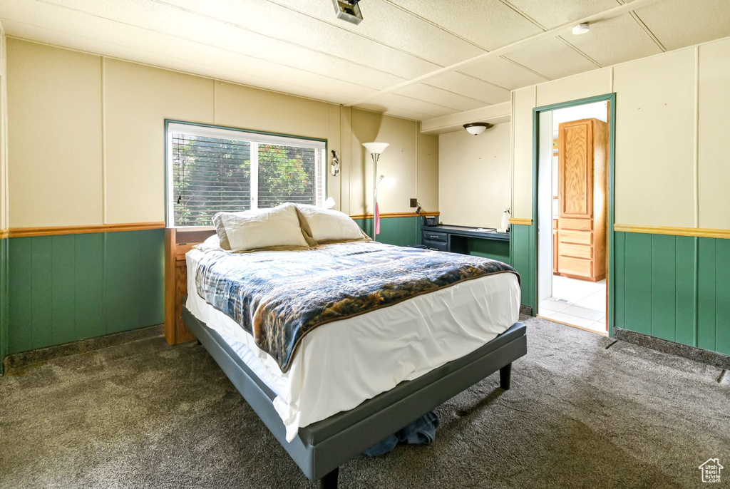 Bedroom featuring carpet flooring and wainscoting