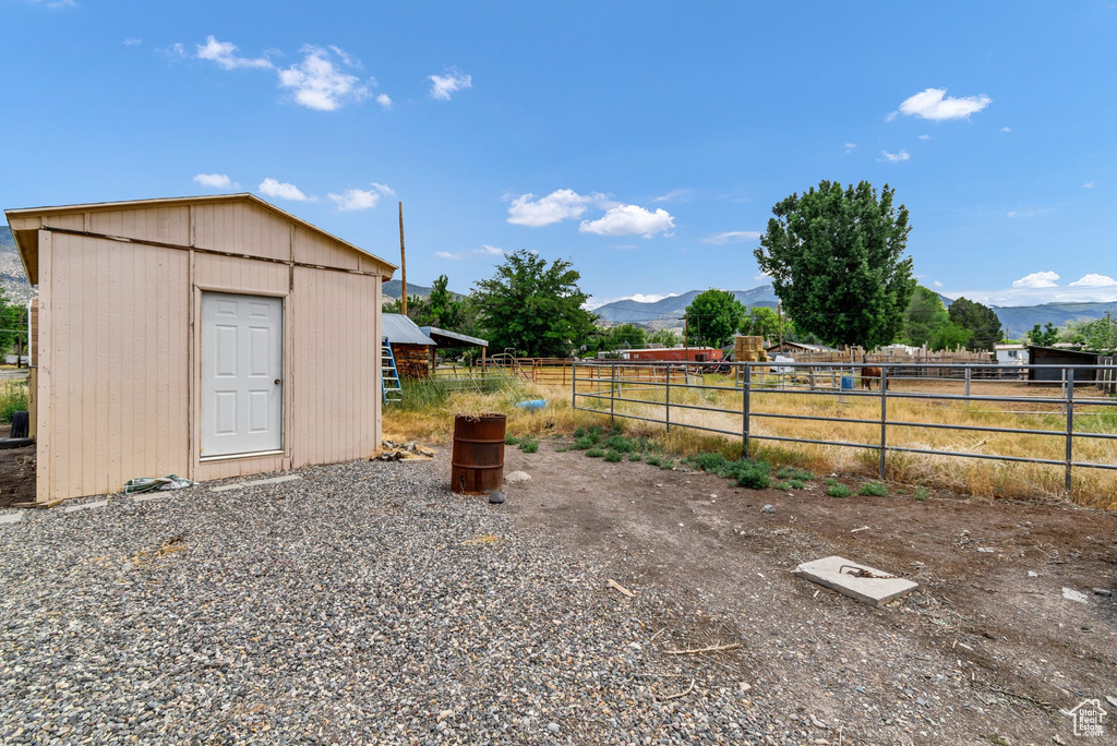 View of yard with a mountain view and an outbuilding
