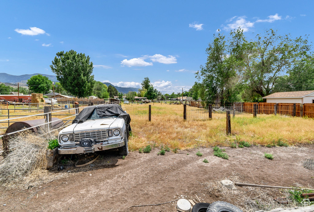 View of yard with a mountain view and a rural view