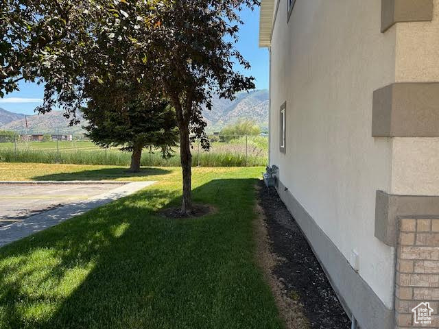 View of grassy yard featuring a mountain view