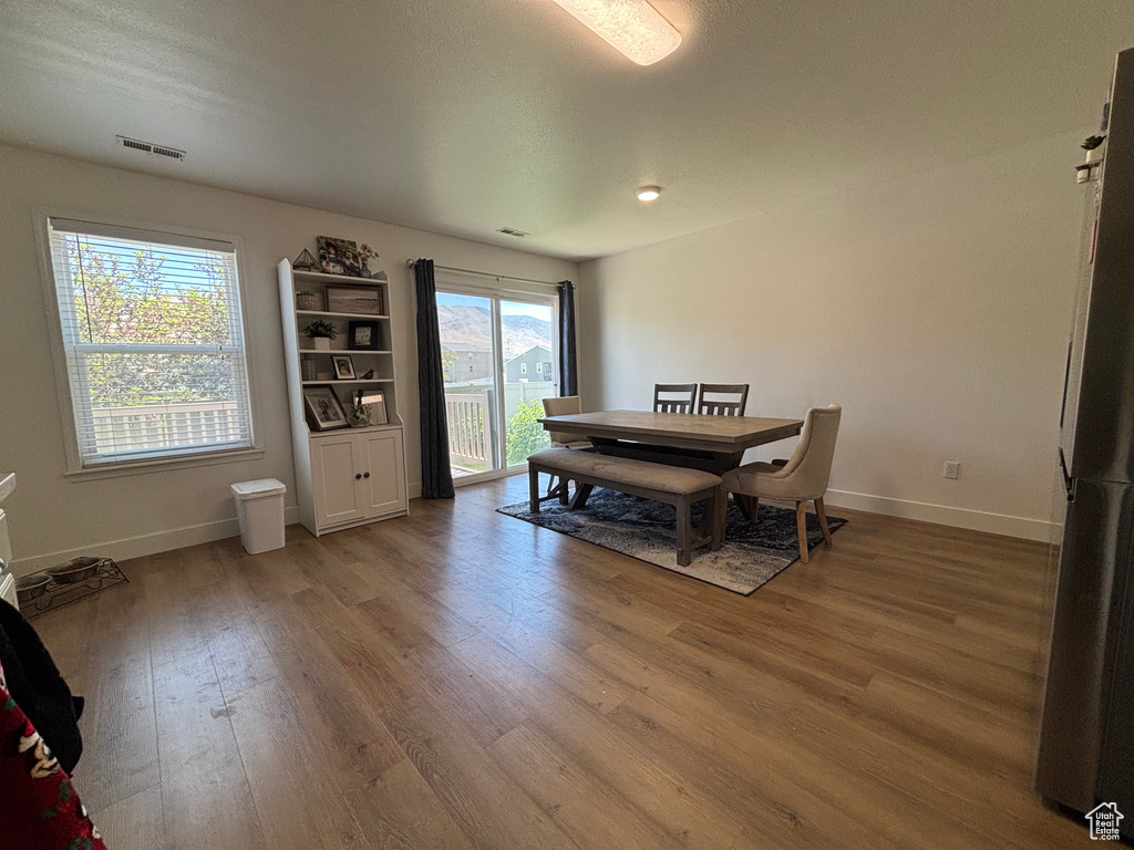 Dining space with baseboards and wood finished floors