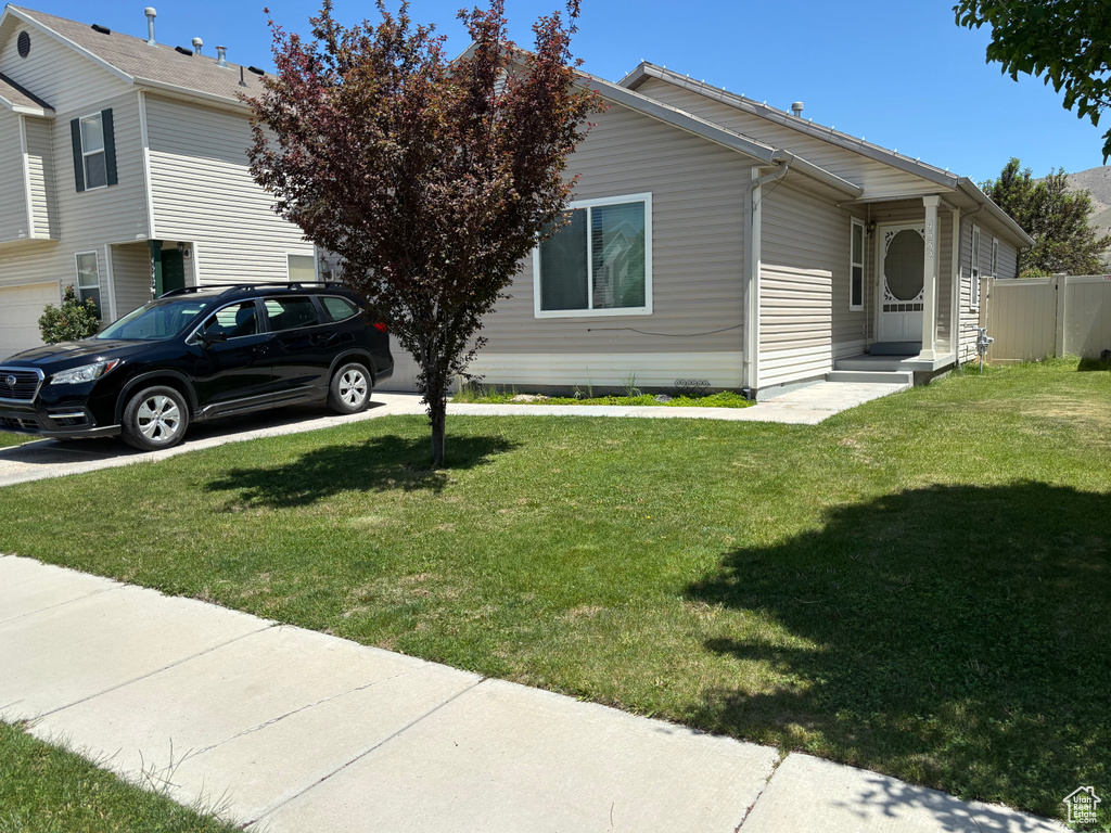 View of property exterior with a yard
