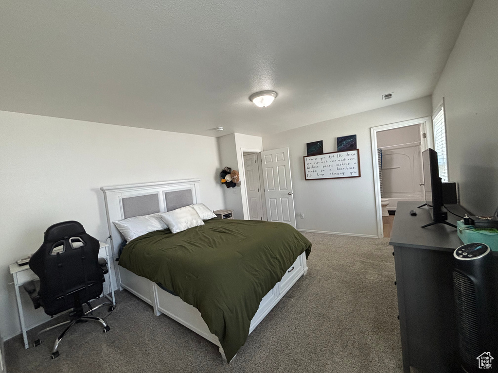 Bedroom featuring carpet floors, an office area, and baseboards