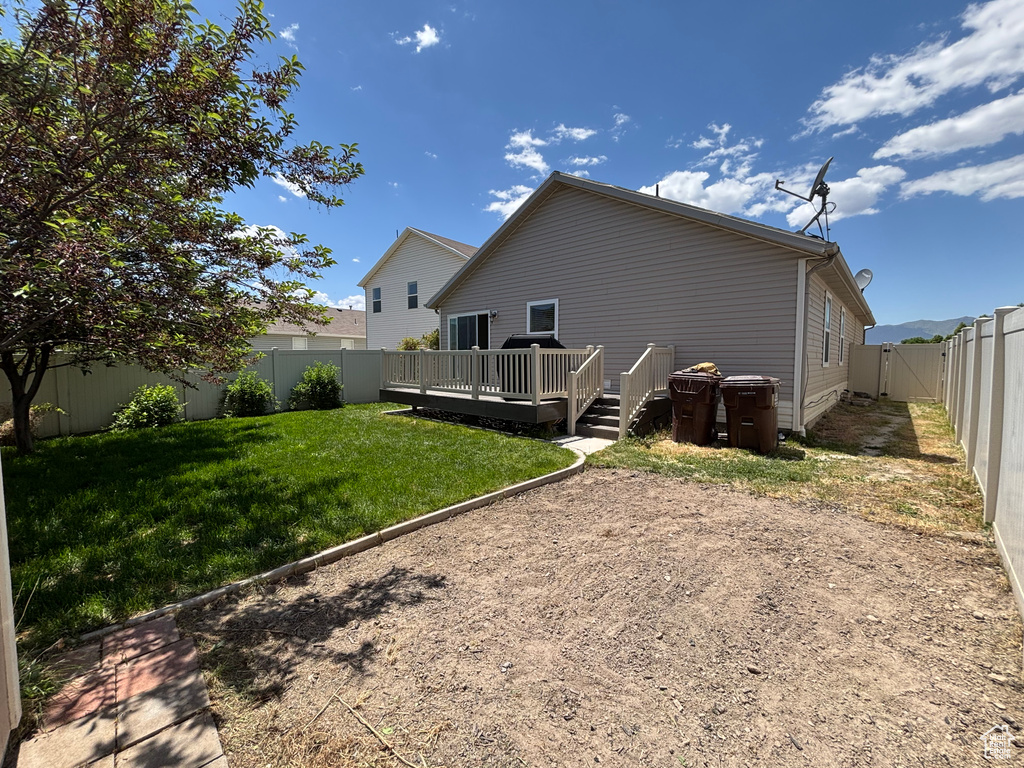Rear view of house with a wooden deck