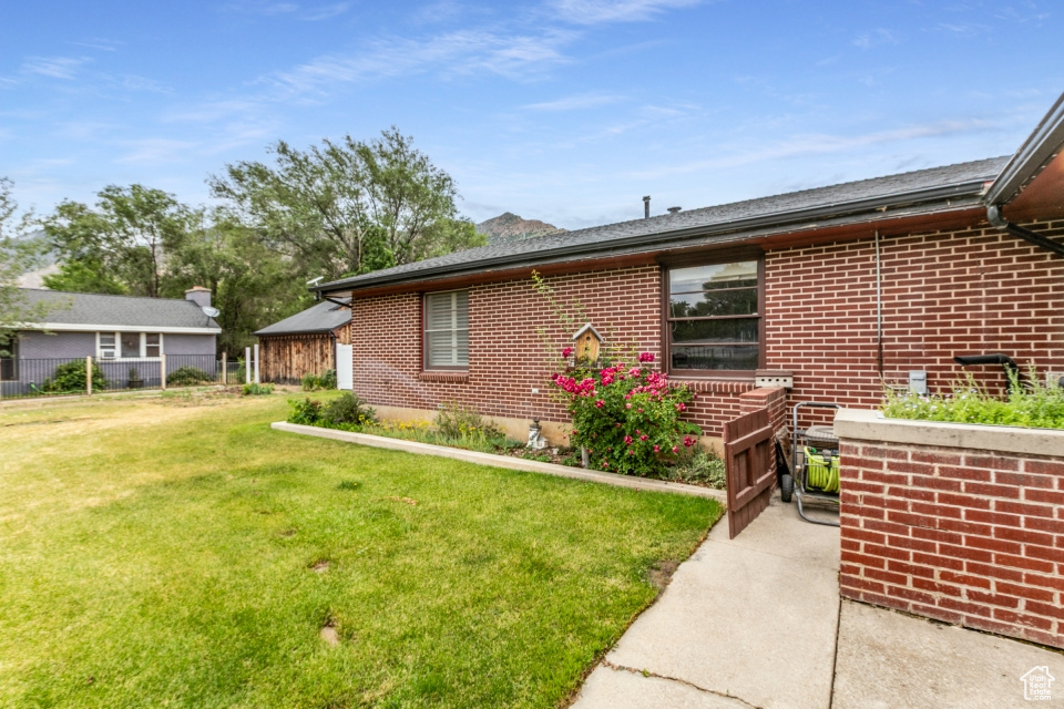 View of side of property featuring brick siding