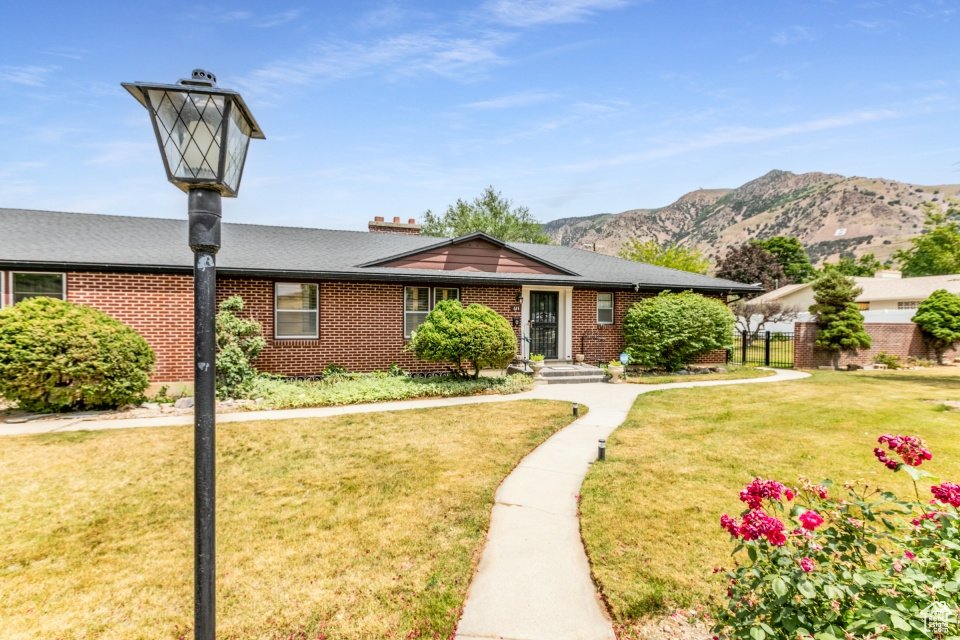 View of front of property with brick siding and a mountain view
