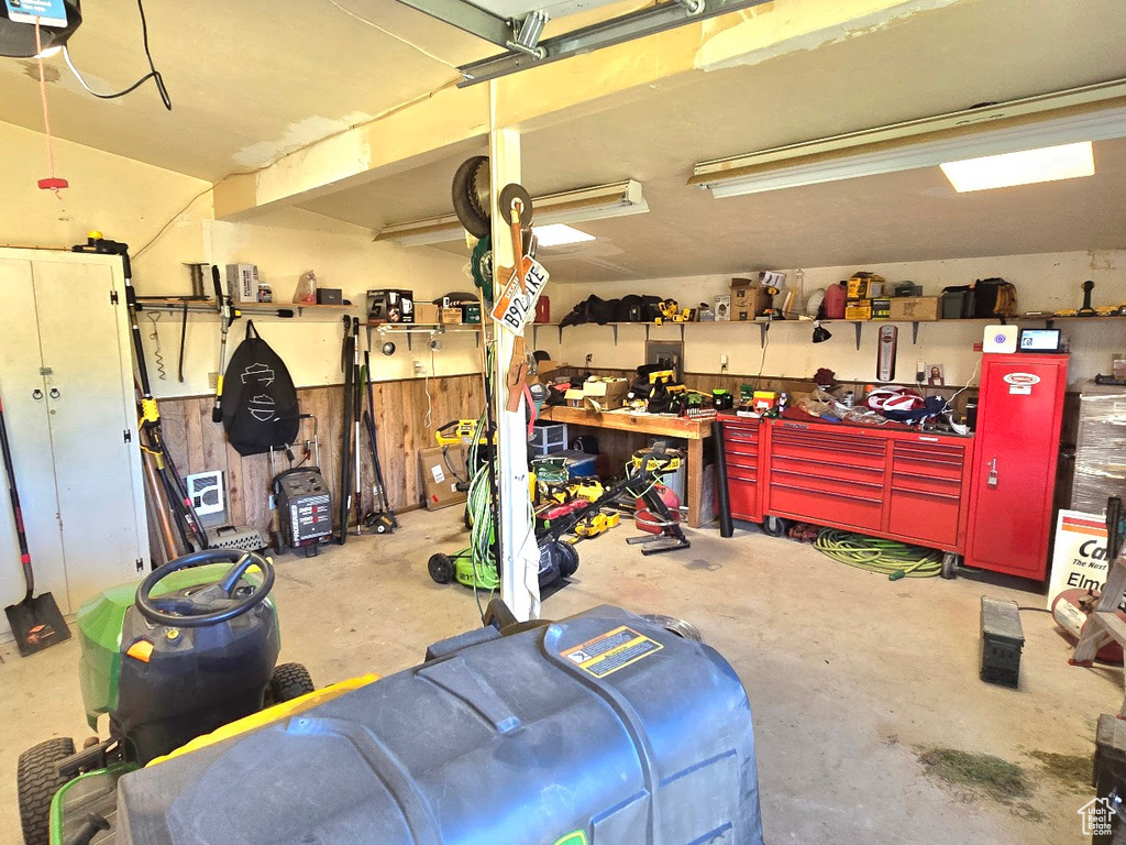 Garage featuring a workshop area and a garage door opener