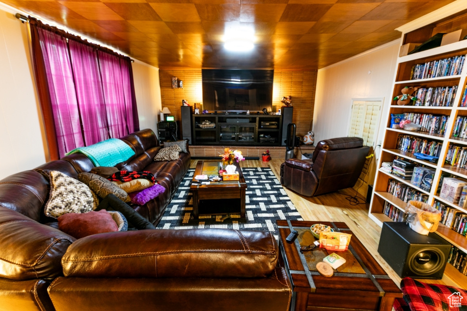 Living area featuring wood walls and wood finished floors