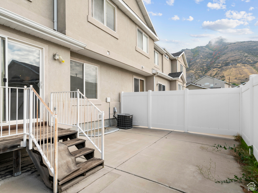 View of patio with a mountain view and central air condition unit