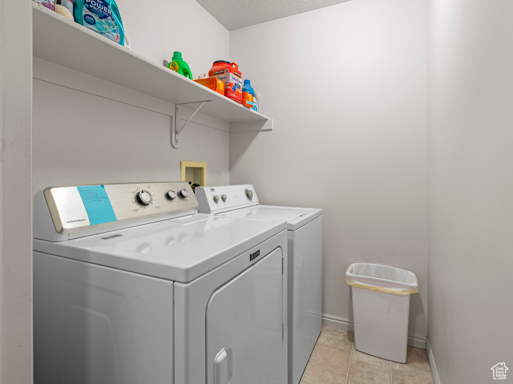Washroom featuring washer and clothes dryer and baseboards