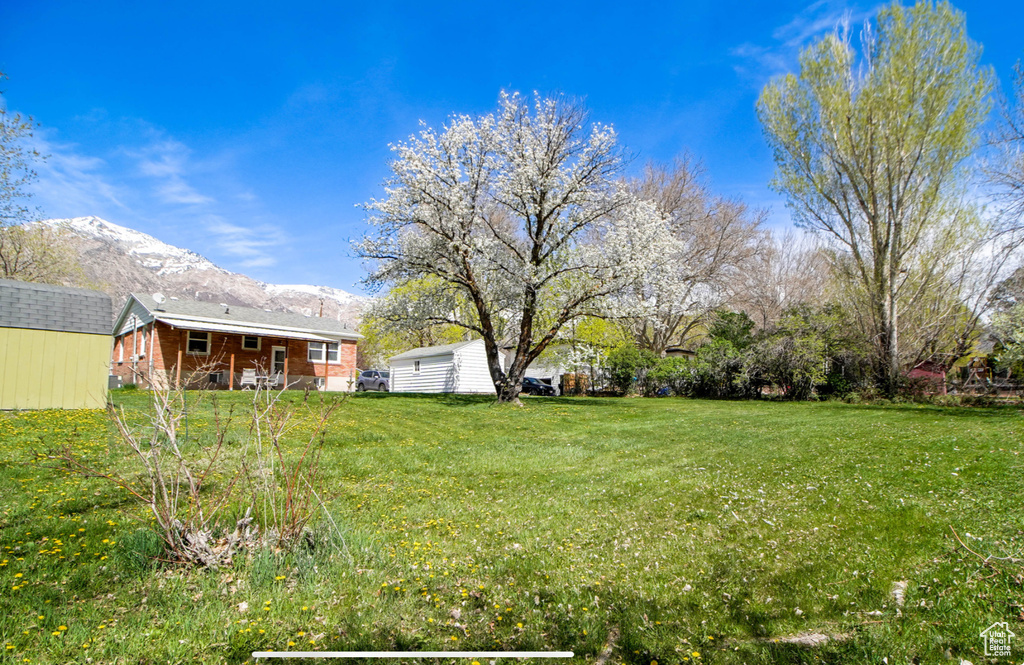 View of green lawn featuring a mountain view