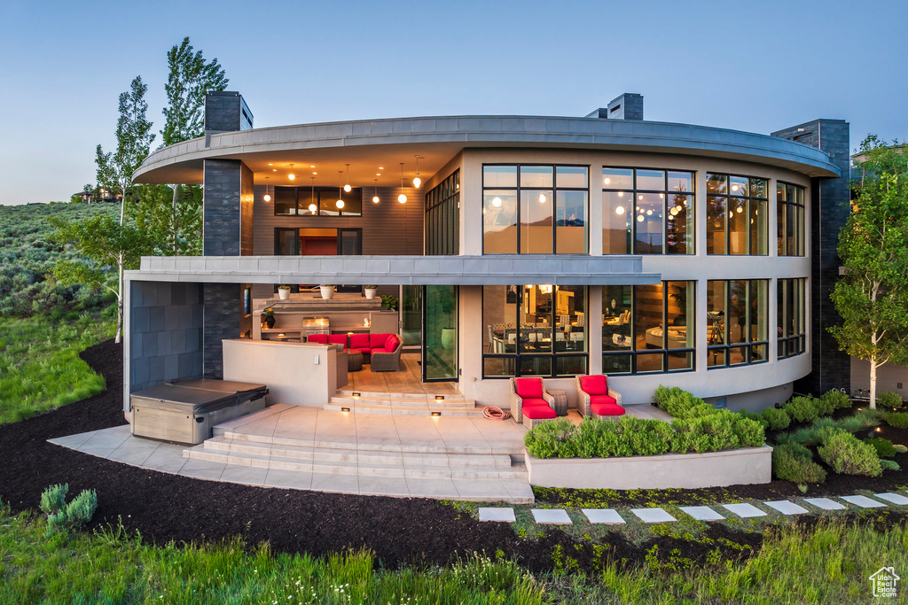 Back of property with a patio, an outdoor hangout area, and a chimney