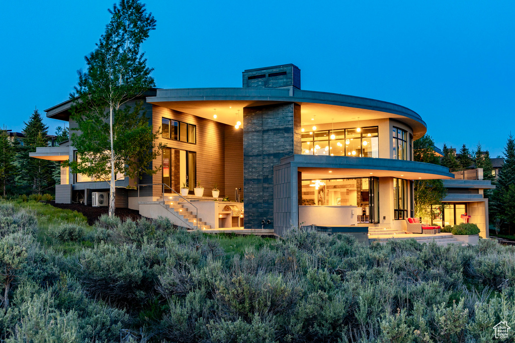Rear view of property with stairs, outdoor lounge area, and a patio area